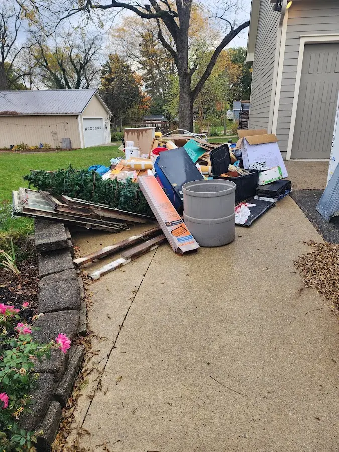 Dumpster being loaded with debris for 30 Yard Dumpster Rental in Yelm